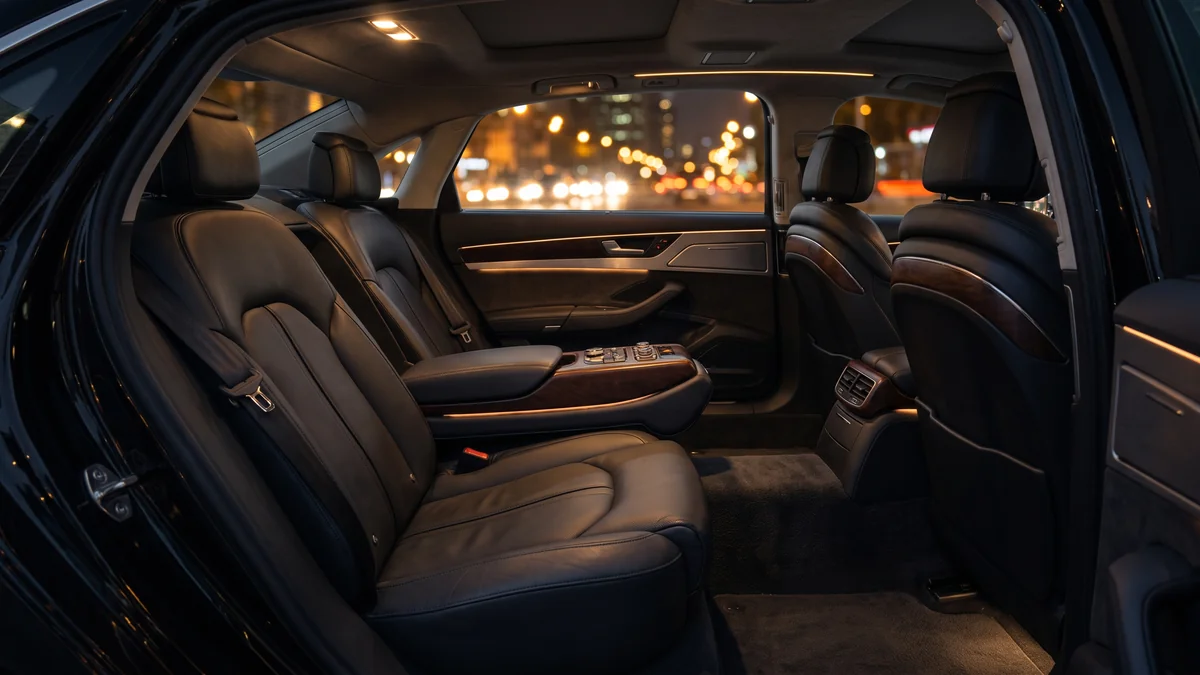 The comfortable ambient-lit interior of a chauffeured saloon for an evening out in Bordeaux