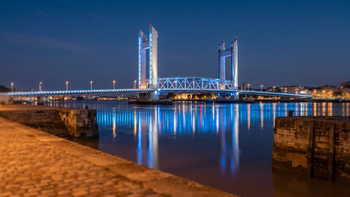 The Chaban-Delmas Bridge, illuminated at night over the Garonne River in Bordeaux