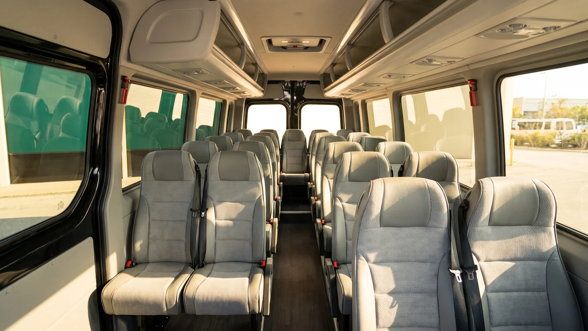 Interior of a minibus with a driver, seats arranged in rows for a group in Bordeaux