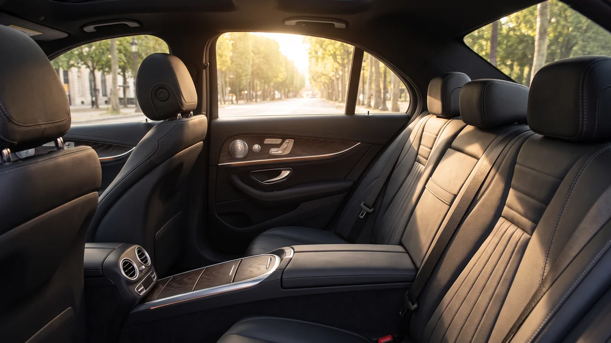 Leather interior of a dedicated chauffeur-driven sedan, including the front seats and dashboard